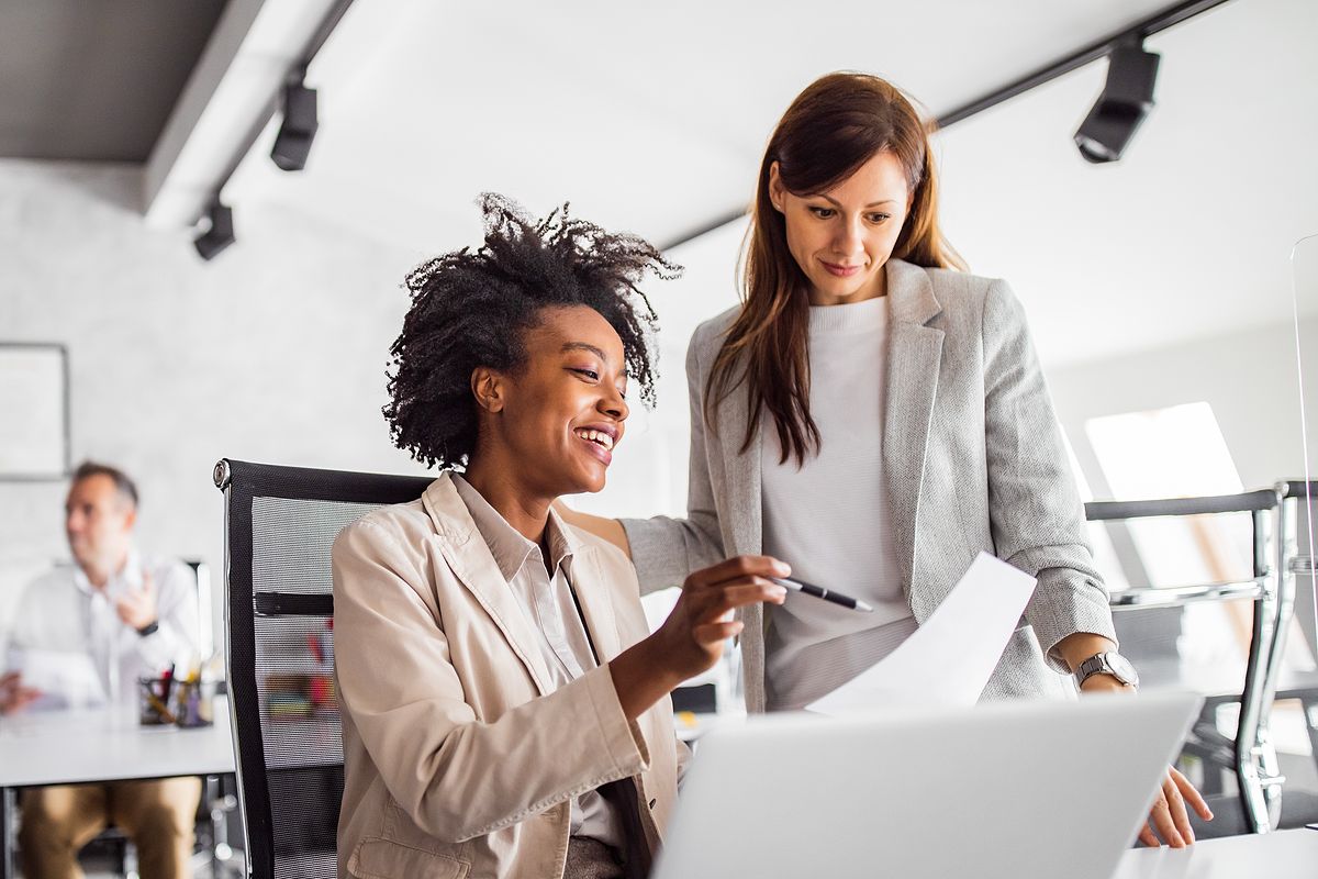 Two professionals review a document.